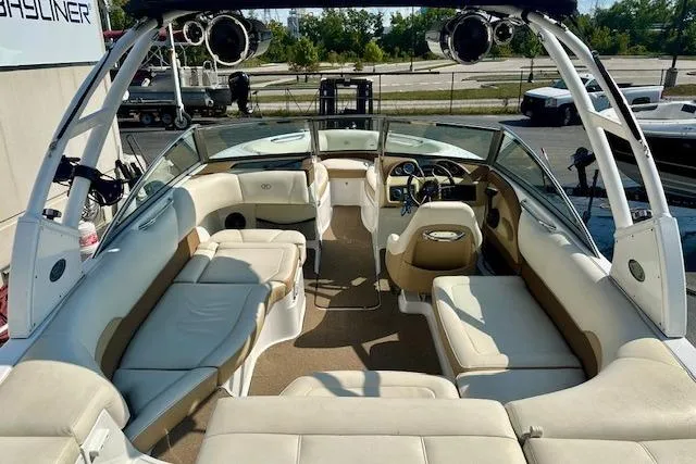 Slide: The Image of 2015 Cobalt 220S boat interior with beige seating and modern dashboard. - 8