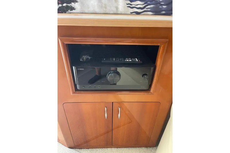 Slide: The Image of Interior of 2004 Carver 570 Voyager Pilothouse with wooden cabinetry and clock. - 10