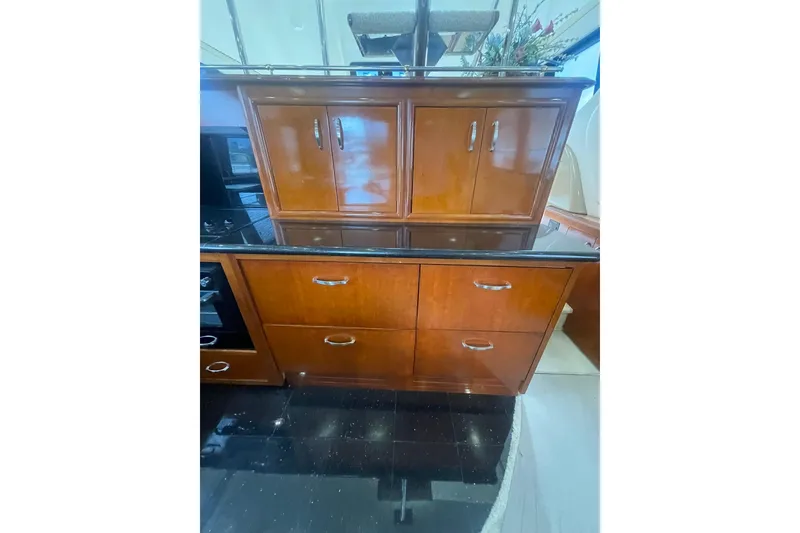 Slide: The Image of Luxurious interior of 2004 Carver 570 Voyager Pilothouse with elegant wood cabinetry and modern amenities. - 12