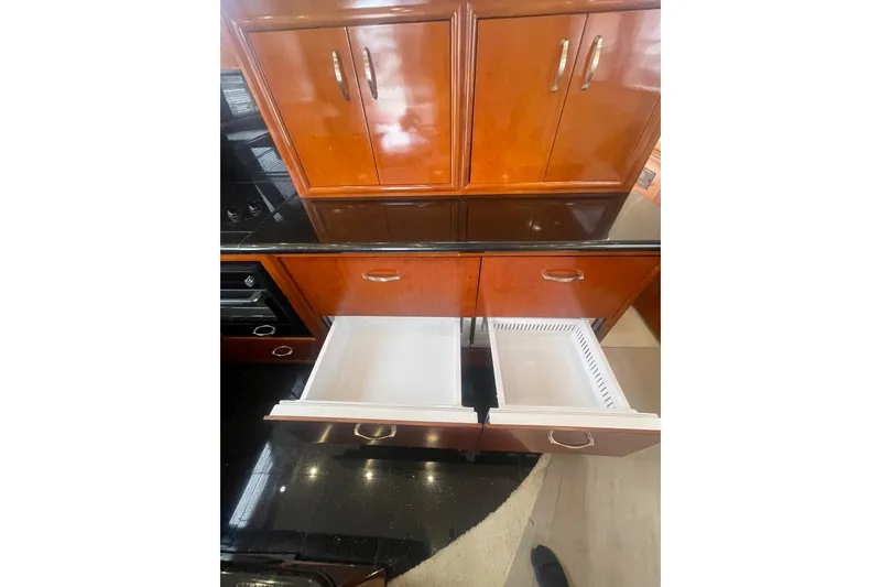 Slide: The Image of Open wooden drawers in a 2004 Carver 570 Voyager Pilothouse yacht kitchen. - 14