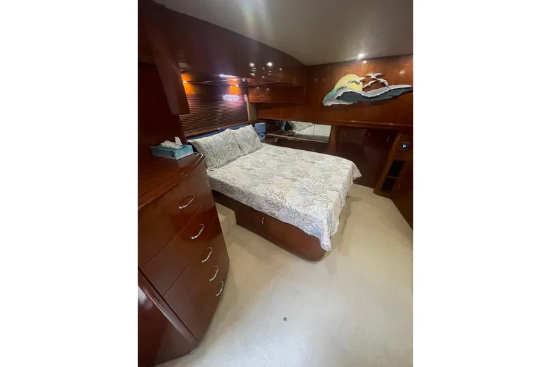 Slide: The Image of Interior of 2004 Carver 570 Voyager Pilothouse with elegant wood finish and carpeted stairs. - 24