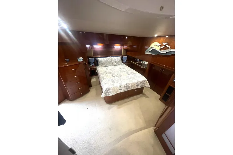 Slide: The Image of Luxurious bedroom in 2004 Carver 570 Voyager Pilothouse yacht with elegant wood finishes. - 25