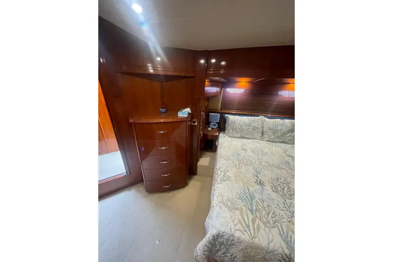 Slide: The Image of Luxurious bedroom interior of 2004 Carver 570 Voyager Pilothouse yacht with elegant wood finish. - 26
