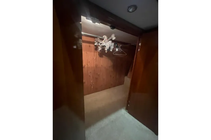 Slide: The Image of Wooden closet interior with hangers in a 2004 Carver 570 Voyager Pilothouse yacht. - 31