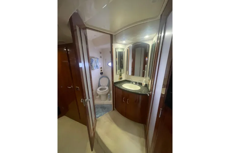Slide: The Image of Luxurious interior of 2004 Carver 570 Voyager Pilothouse yacht with wood paneling and vanity. - 35