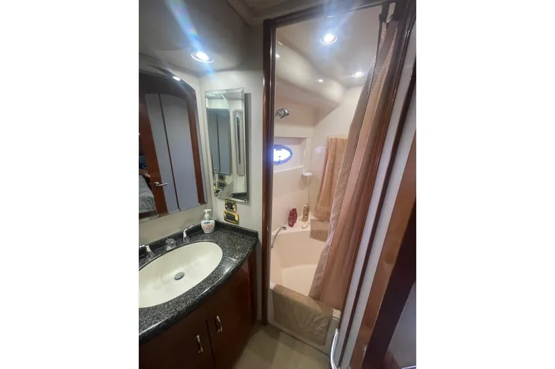 Slide: The Image of Bathroom interior of 2004 Carver 570 Voyager Pilothouse yacht with towels and window. - 37