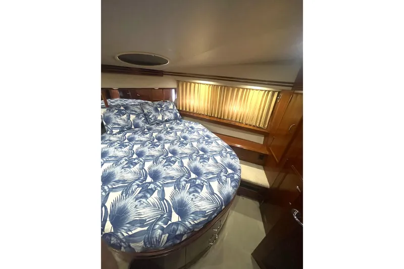 Slide: The Image of Luxurious bedroom interior of 2004 Carver 570 Voyager Pilothouse yacht with elegant bedding. - 42