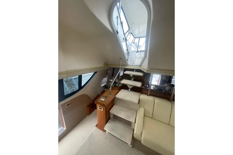 Slide: The Image of Luxurious interior of 2004 Carver 570 Voyager Pilothouse with plush seating and modern helm. - 51