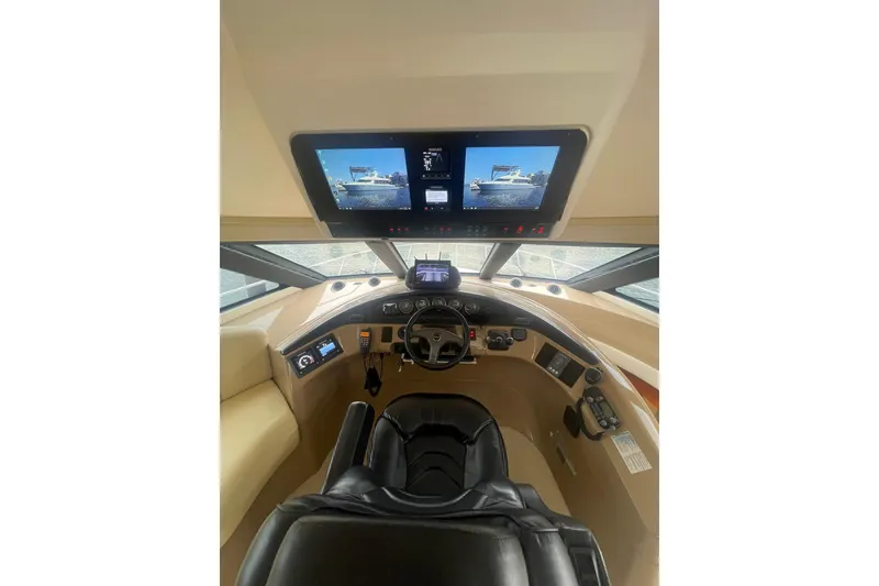 Slide: The Image of Pilothouse interior of 2004 Carver 570 Voyager, featuring modern navigation displays and controls. - 53