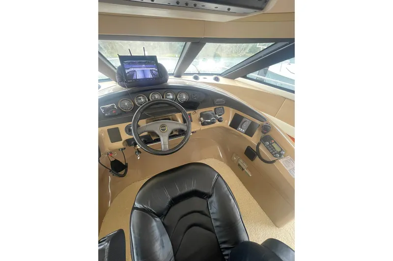 Slide: The Image of Pilothouse of 2004 Carver 570 Voyager with dual screens and navigation controls. - 55
