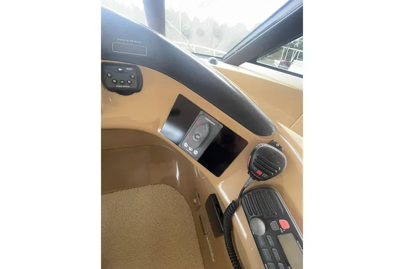 Slide: The Image of Interior view of 2004 Carver 570 Voyager Pilothouse helm with steering wheel and controls. - 56