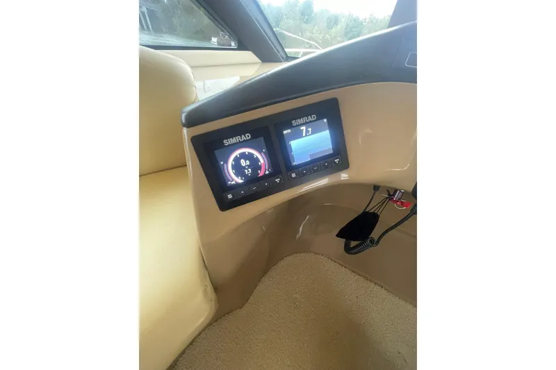 Slide: The Image of Pilothouse interior of 2004 Carver 570 Voyager, featuring steering wheel and navigation instruments. - 58
