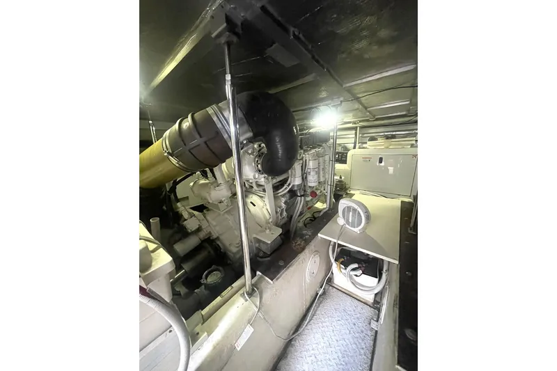Slide: The Image of Engine room of 2004 Carver 570 Voyager Pilothouse, showcasing mechanical components and systems. - 63