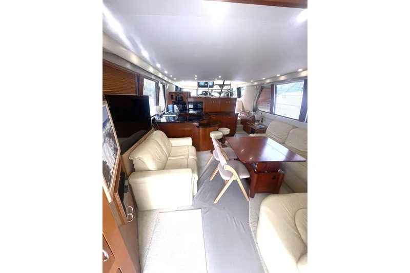 Slide: The Image of Luxurious interior of 2004 Carver 570 Voyager Pilothouse with plush seating and elegant wood finishes. - 7