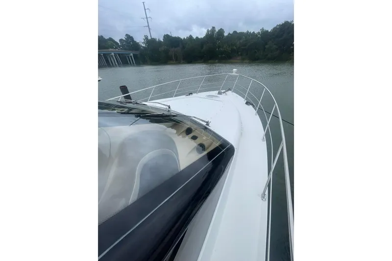 Slide: The Image of Interior of 2004 Carver 570 Voyager Pilothouse with white seating and panoramic windows. - 73