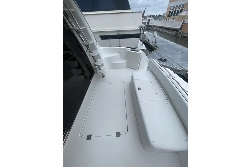 Slide: The Image of 2004 Carver 570 Voyager Pilothouse boat deck with seating, dockside view. - 79
