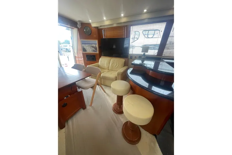 Slide: The Image of Luxurious interior of 2004 Carver 570 Voyager Pilothouse with elegant seating and dining area. - 8