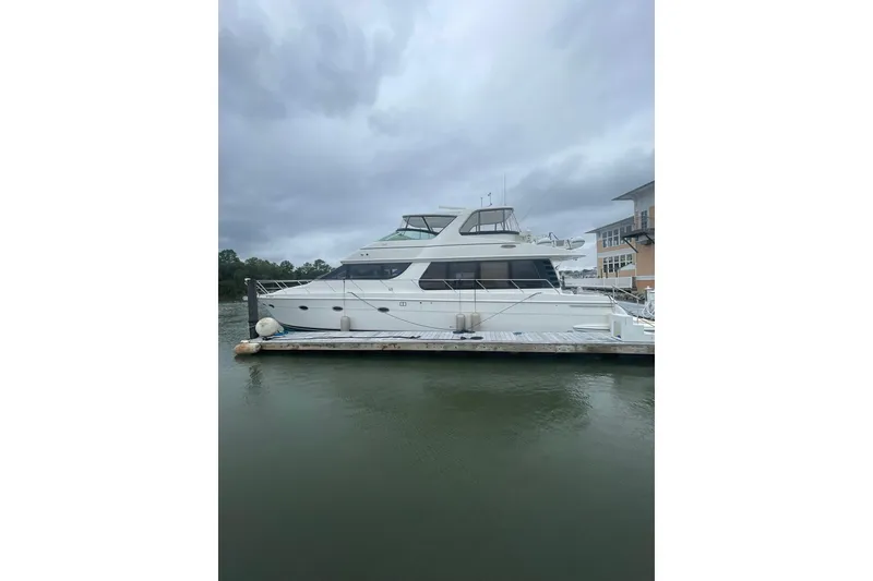 Slide: The Image of 2004 Carver 570 Voyager Pilothouse yacht docked on a cloudy day. - 85
