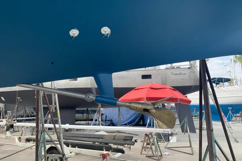 Slide: The Image of 1980 Nautor Swan 47 sailboat with blue cockpit cover and teak deck. - 12