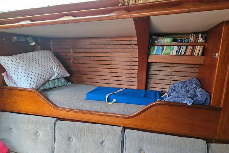Slide: The Image of Interior of 1980 Nautor Swan 47 yacht with wooden furnishings and gray seating. - 22