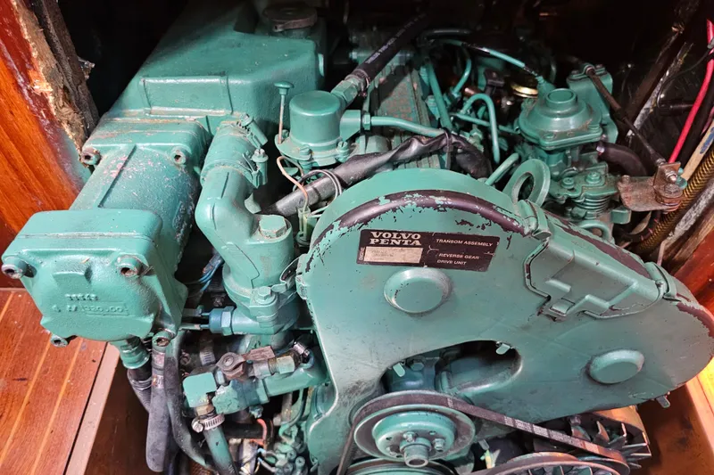 Slide: The Image of Cozy cabin interior of 1980 Nautor Swan 47 sailboat with wooden finish and cushioned seating. - 29