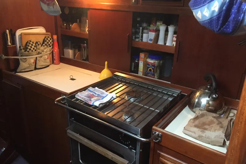 Slide: The Image of Nautor Swan 47 yacht bathroom with manual marine toilet, wooden paneling, and sink, 1980 model. - 32