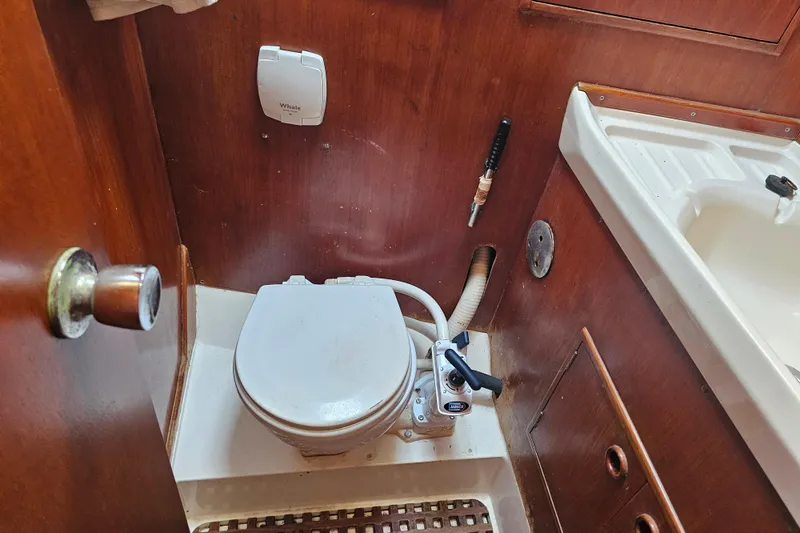 Slide: The Image of Fuel tank connections on a 1980 Nautor Swan 47 yacht, showing metal pipes and bolts. - 34