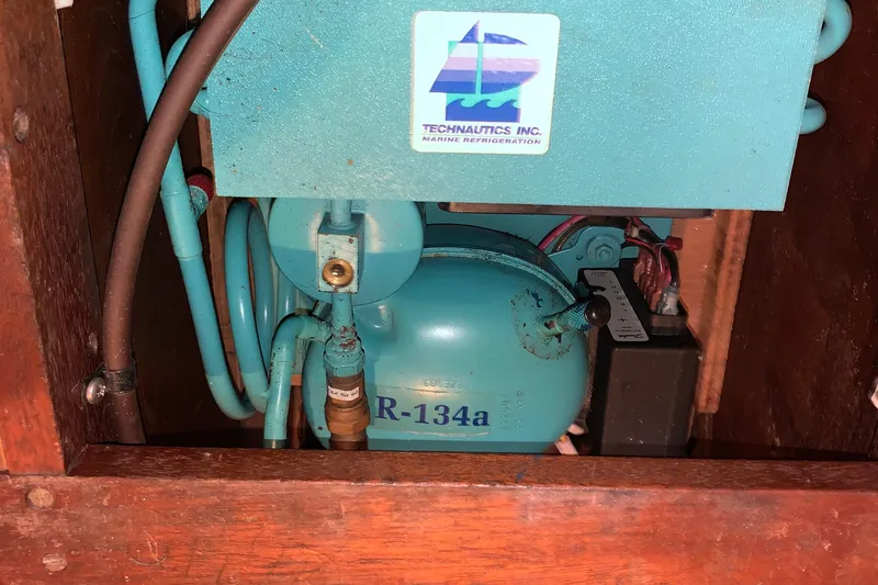 Slide: The Image of Interior of 1980 Nautor Swan 47 yacht, featuring polished wooden paneling and nautical details. - 38