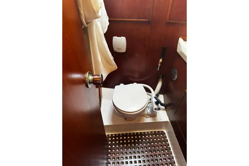 Slide: The Image of Nautor Swan 47 yacht bathroom with wooden paneling and marine toilet, 1980 model. - 40