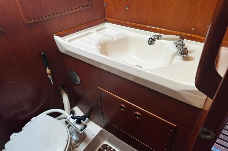 Slide: The Image of Interior of 1980 Nautor Swan 47 yacht showing bathroom sink and toilet. - 41