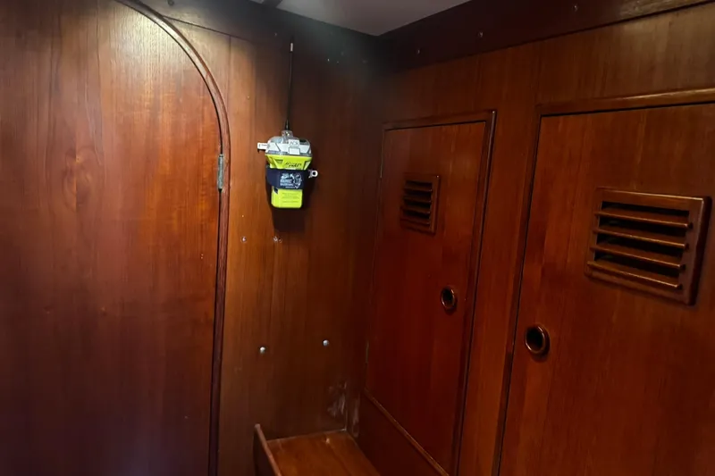 Slide: The Image of Wooden interior of 1980 Nautor Swan 47 yacht with storage compartments and mounted device. - 42