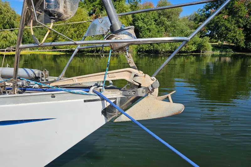 Slide: The Image of Nautor Swan 47 sailboat from 1980 on dry dock with blue hull and support stands. - 9
