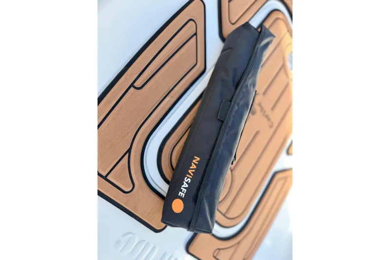 Slide: The Image of Navy blue Navisafe bag on Caribe MPV 10, 2025 model, with brown patterned background. - 22