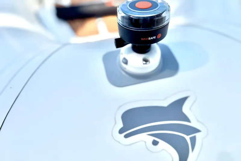 Slide: The Image of Close-up of a 2025 Caribe MPV 10 with a Navisafe light and dolphin logo. - 24