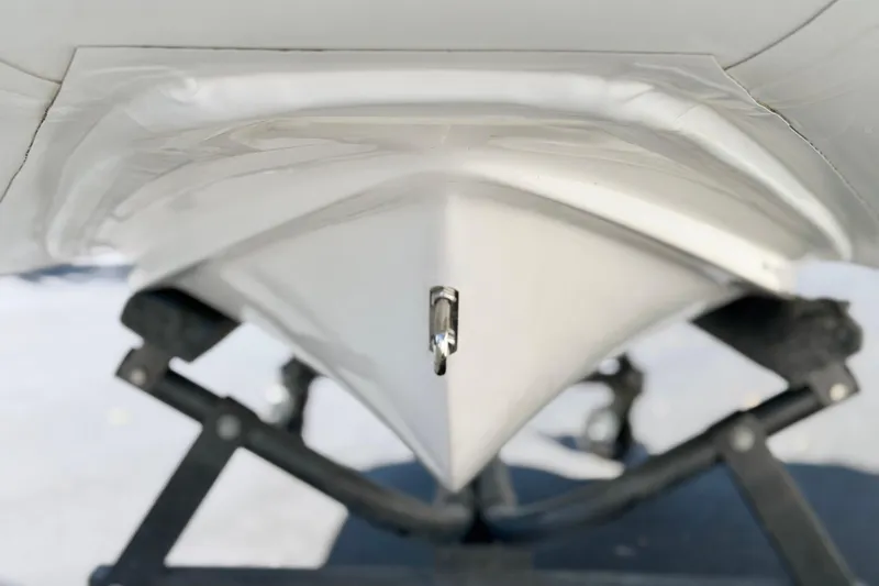 Slide: The Image of Underneath view of 2025 Caribe MPV 10 boat hull on a stand. - 28