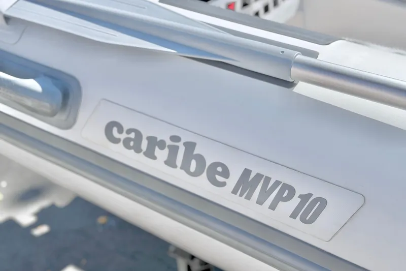 Slide: The Image of 2025 Caribe MPV 10 boat detail with logo and sleek design. - 34