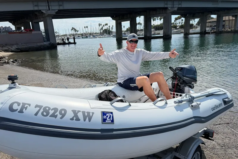 Slide: The Image of ```plaintext Man in inflatable boat near bridge, smiling and giving thumbs up. ``` - 41