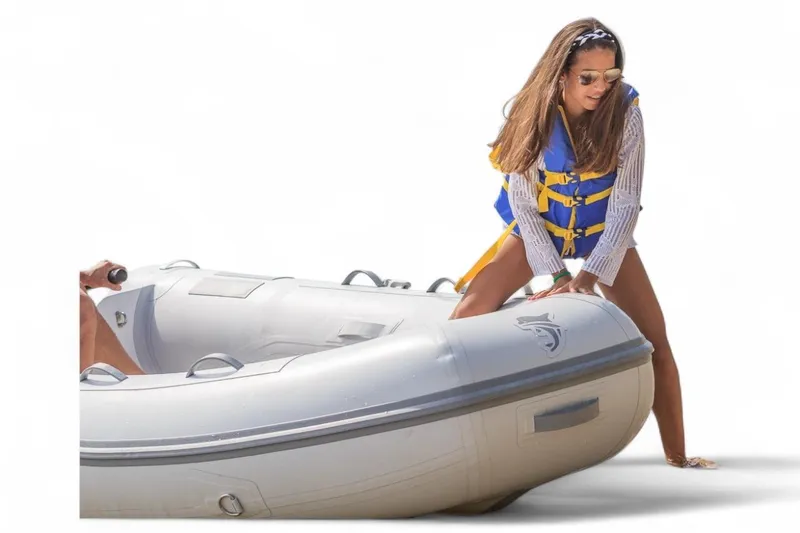 Slide: The Image of Woman in life jacket with inflatable boat, Caribe MPV 10, 2025 model. - 50