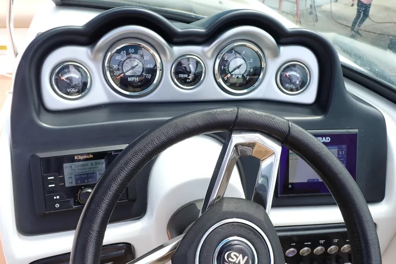 Slide: The Image of Dashboard of 2019 NauticStar 243DC Sport Deck with gauges and steering wheel. - 11