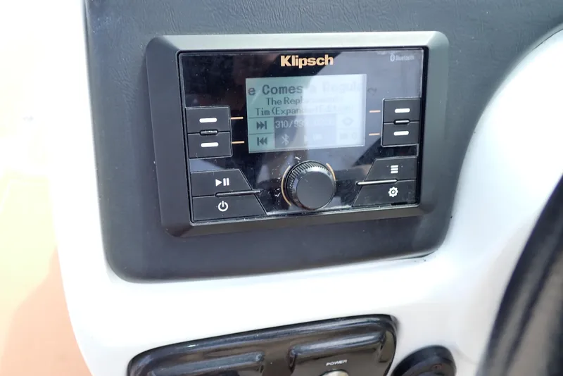 Slide: The Image of Klipsch audio system on 2019 NauticStar 243DC Sport Deck boat dashboard. - 12