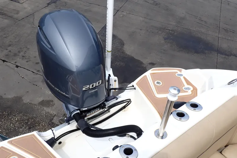 Slide: The Image of 2019 NauticStar 243DC Sport Deck boat with Yamaha 200 engine, docked. - 16