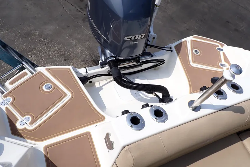 Slide: The Image of 2019 NauticStar 243DC Sport Deck boat with Yamaha 200 engine, featuring tan and white deck. - 18