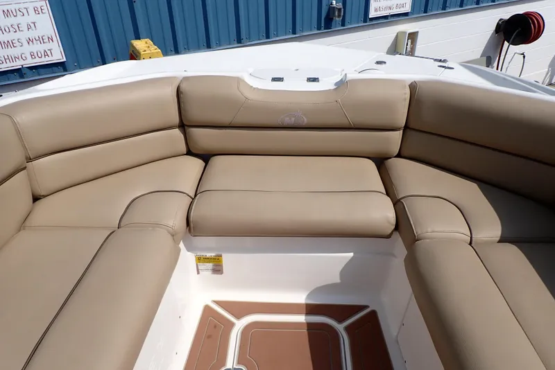 Slide: The Image of 2019 NauticStar 243DC Sport Deck boat with tan seating and spacious interior. - 25