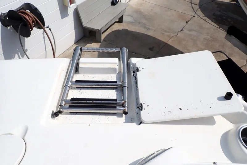 Slide: The Image of 2019 NauticStar 243DC Sport Deck boat with foldable ladder on deck. - 27