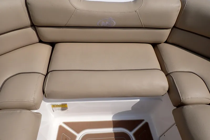 Slide: The Image of 2019 NauticStar 243DC Sport Deck boat with beige cushioned seating. - 32