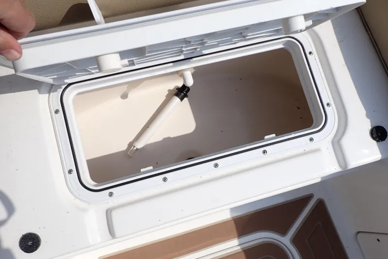 Slide: The Image of Open storage compartment on 2019 NauticStar 243DC Sport Deck boat. - 34