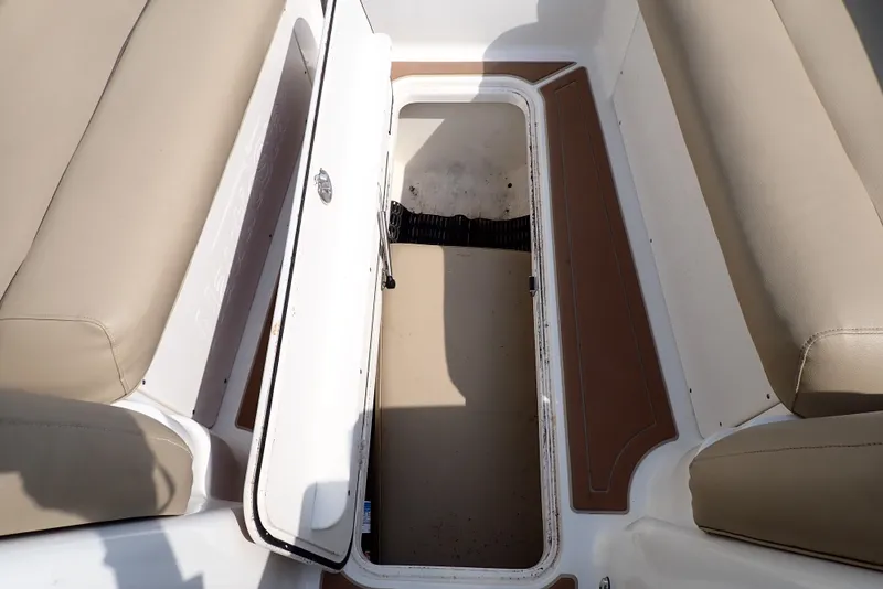 Slide: The Image of 2019 NauticStar 243DC Sport Deck interior storage compartment with open hatch. - 38