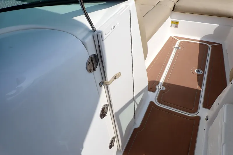 Slide: The Image of 2019 NauticStar 243DC Sport Deck interior with brown flooring and seating. - 40
