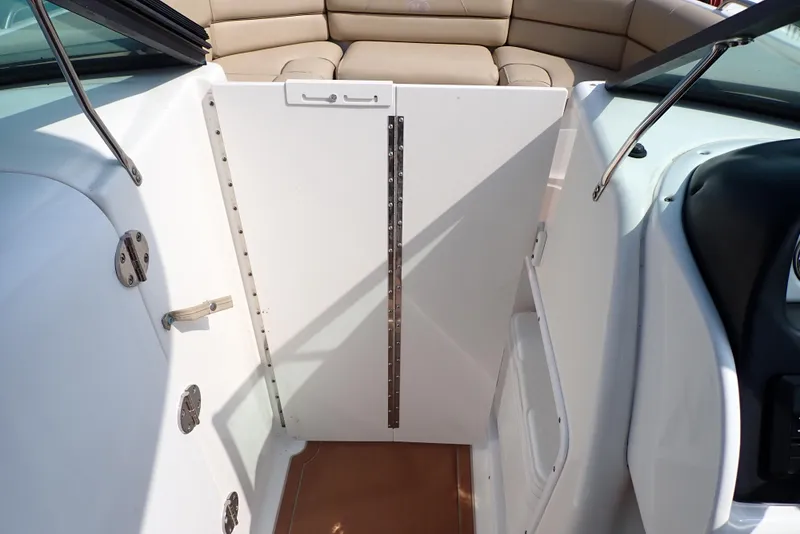 Slide: The Image of 2019 NauticStar 243DC Sport Deck interior with seating and door. - 41