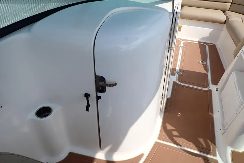 Slide: The Image of 2019 NauticStar 243DC Sport Deck interior with seating and storage compartment. - 42